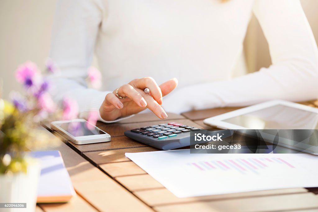 Businesswoman using calculator Calculator Stock Photo