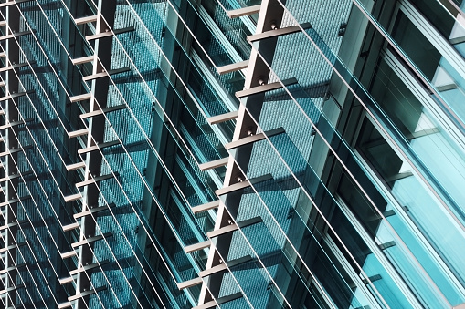 Tilt double exposure photo of contemporary industrial or office building fragment. Glance at business cityscape. Abstract modern architecture exterior with glazed aluminum structures.