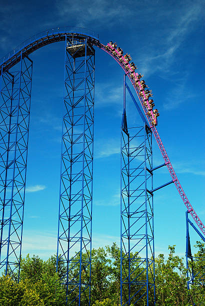 People upside-down in rollercoaster at sunset, Florida