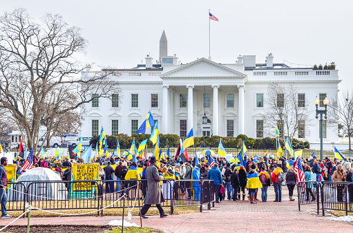 Washington DC, USA - March 6, 2014: Crowd of people at Ukrainian protest by White House with flags and monument