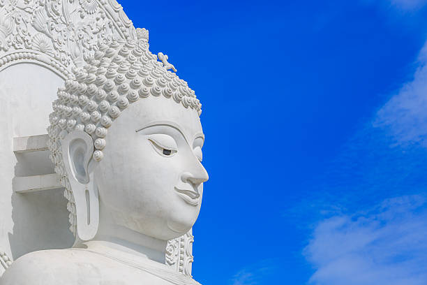 istock The White buddha statue on blue sky background 622055052