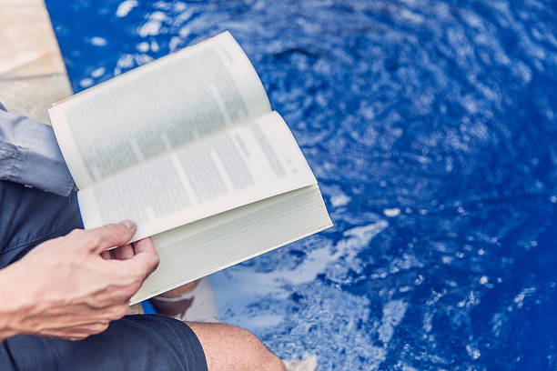 istock Adult man reading novel 622055920