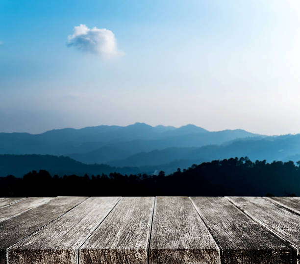 istock Wooden tabletop with beautiful silhouette mountain range in winter 622056652