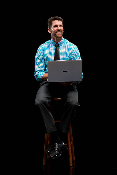 istock Smiling businessman working on laptop 622058484