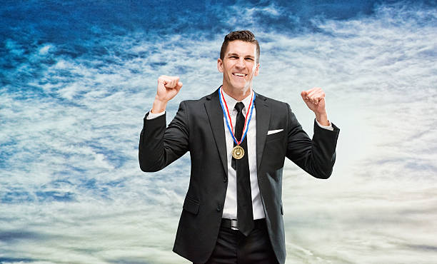 istock Smiling businessman cheering outdoors 622061252
