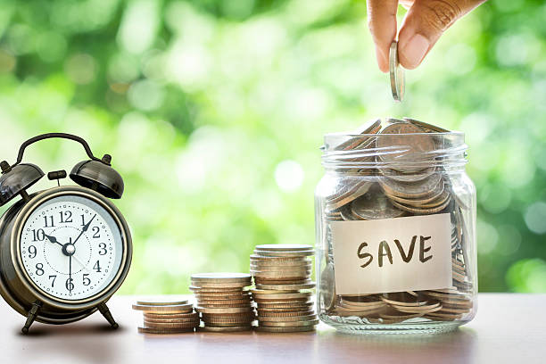 istock Hand putting Coins in glass jar , time for  money saving 622064096