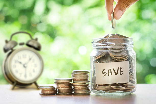 istock Hand putting Coins in glass jar , time for  money saving 622064124