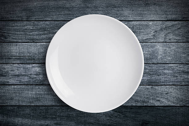 istock Simple white circular porcelain plate on wood background 622064760