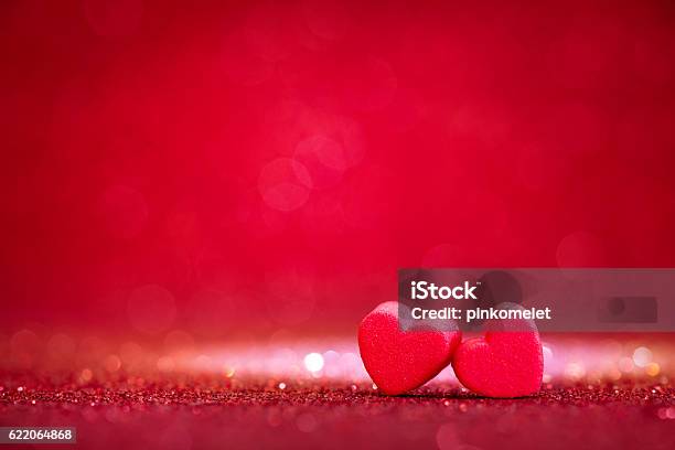 Red Heart Shapes On Abstract Light Glitter Background Stock Photo - Download Image Now