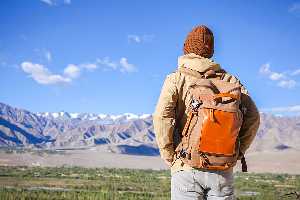 istock Young male travel backpacker watching mountains 622065360