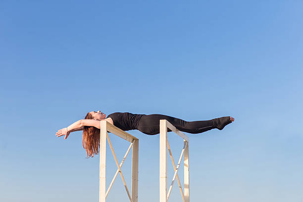 istock Young woman doing yoga on the roof 622068310