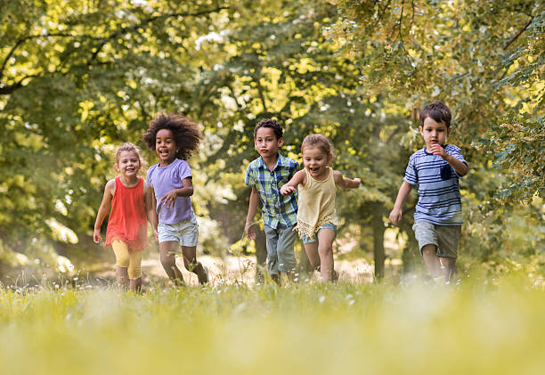 istock Small carefree friends running together during spring day. 622069928