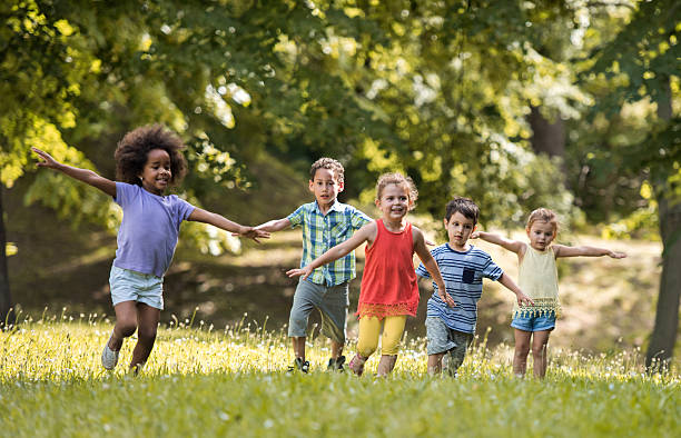 istock Group of happy children having fun while running in nature. 622070022