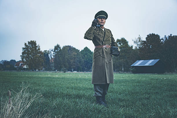 istock Retro 1940s military officer calling with field phone. 622070908