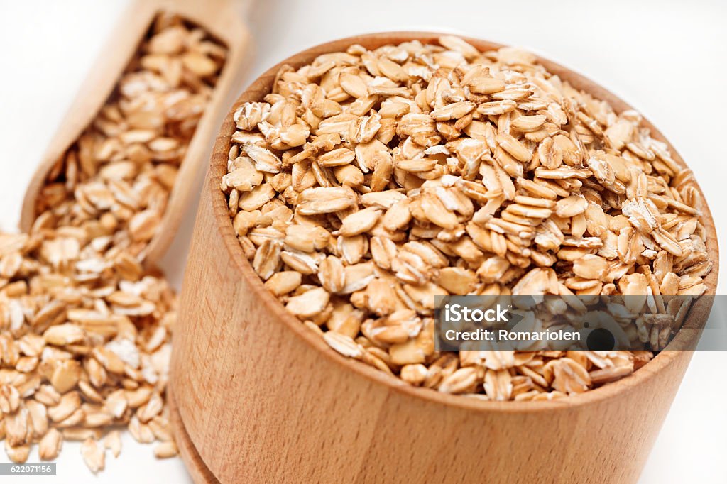 Close up of oatmeal in bowl and scoop Close up of oatmeal in bowl and scoop on white background. Healthy food. Top view, high resolution product Bowl Stock Photo