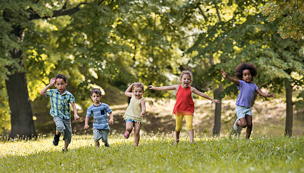 istock Carefree children having fun while running in the park. 622071636