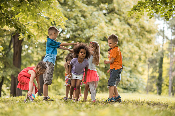 istock Group of small kids having fun while playing in nature. 622072204