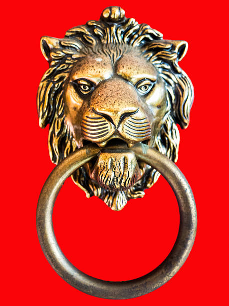 istock Bronze lion door knocker on red background 622073902