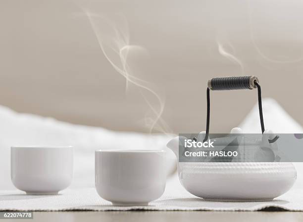 White Teapot And Cups On Table At Comfortable Relaxation Lounge Stock Photo - Download Image Now