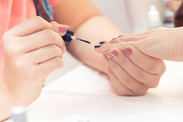 beautician applying polish nails to women - brushing women make up ceremonial makeup imagens e fotografias de stock