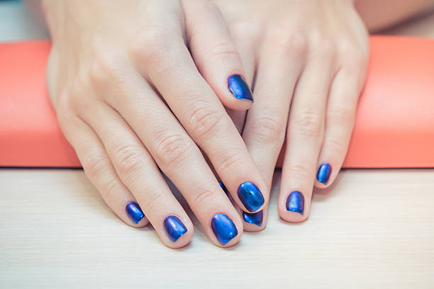 istock female hands with  blue nail Polish, close-up 622077766