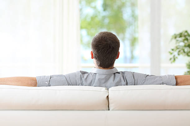 istock Man relaxing on a couch at home 622178076