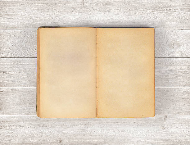 istock Open old book on wood background. 622178224