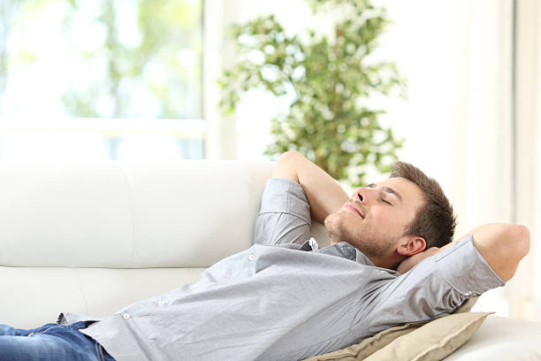 istock Relaxed man resting on a couch at home 622178632