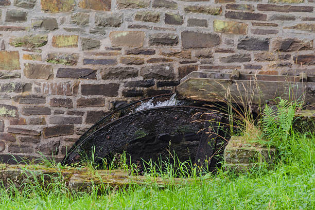 Restored Mill Wheel of an old Water Mill Reconstituted and restored mill wheel of an old water mill in Germany. burton sussex stock pictures, royalty-free photos & images