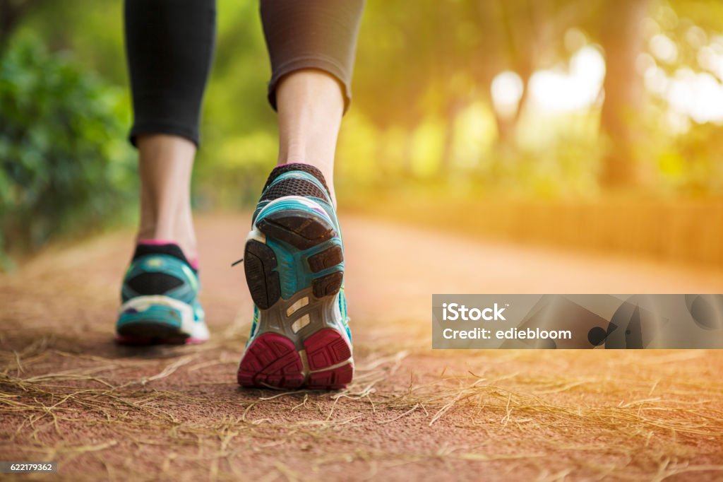 Close up shot of runner's shoes Woman running on a path.close up. Walking Stock Photo