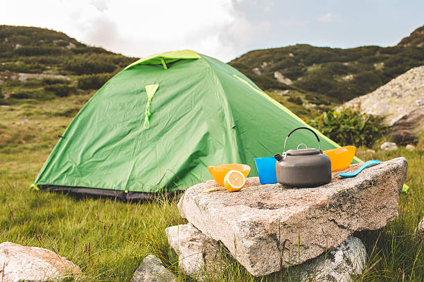 istock Camping teapot and cap on the grass 622179680