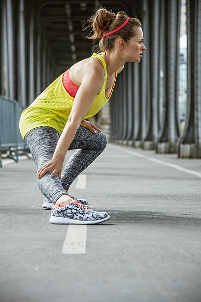 istock active woman stretching on Pont de Bir-Hakeim bridge in Paris 622181028