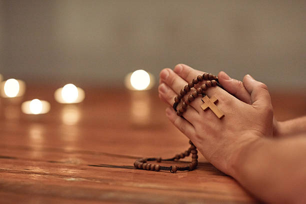 Prayer can change everything Cropped shot of a man holding a rosary and praying rosary beads stock pictures, royalty-free photos & images