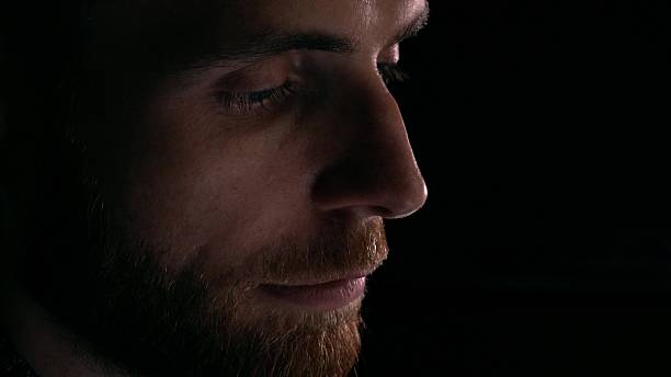 istock Profile view of focused intelligent bearded young man using his 622182208