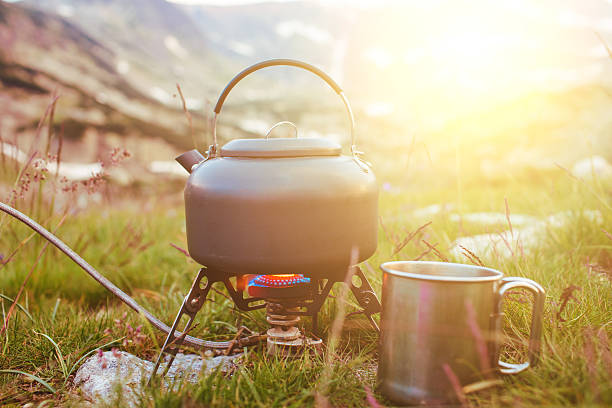 istock Camping teapot and cap on the grass 622183736