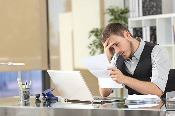 istock Sad businessman reading a letter at office 622184400