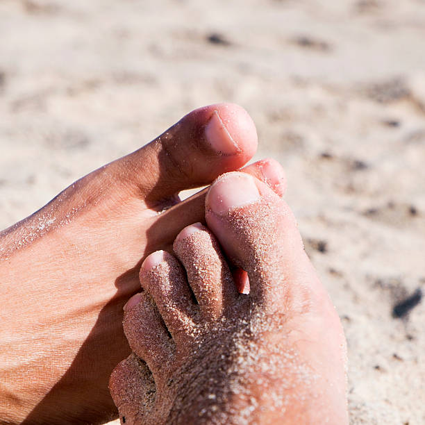 istock men playing footsie on the beach 622184480
