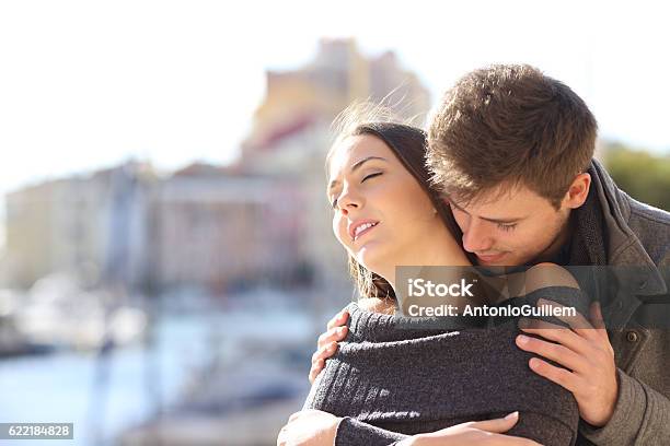 Couple Flirting With Passion In The Street Stock Photo - Download Image Now - Perfume, Women, Men