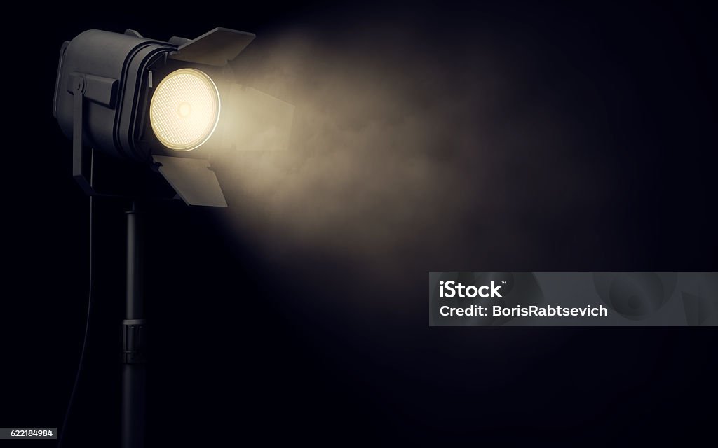 Stage spotlight in dark background Warm stage spotlight shines in dark background Spotlight Stock Photo