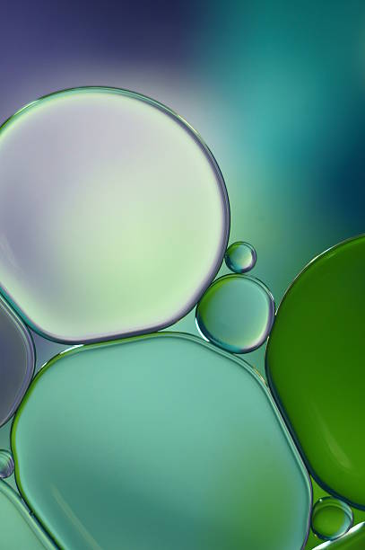 istock Oil drops on water surface- abstract macro- blue, green (399) 622185160