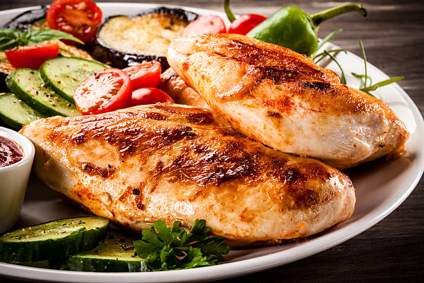 istock Fried chicken fillets and vegetables on wooden background 622185412