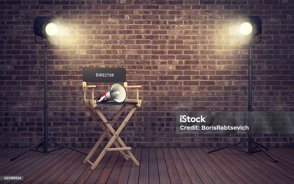 Film director's chair with megaphone and spotlights. 3D renderin Film director's chair with megaphone and spotlights shining. 3D rendering Movie Stock Photo