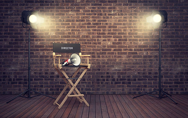 Film director's chair with megaphone and spotlights. 3D renderin Film director's chair with megaphone and spotlights shining. 3D rendering director stock pictures, royalty-free photos & images