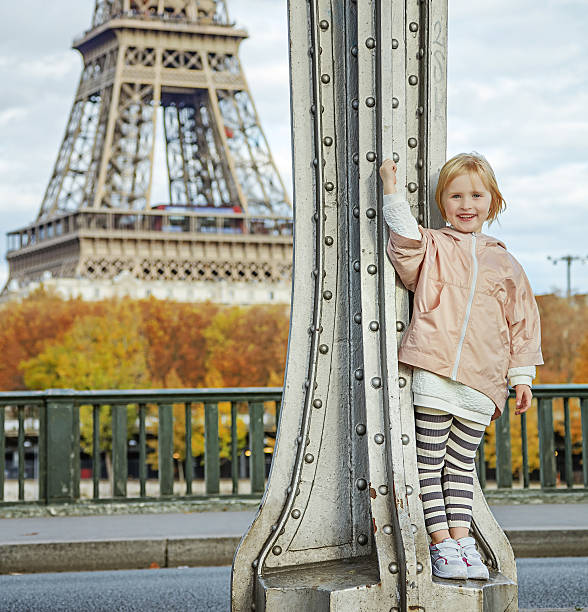 istock happy child in sport style clothes against Eiffel tower, Paris 622185780