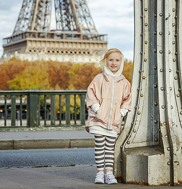 istock happy active girl standing on Pont de Bir-Hakeim bridge, Paris 622185806