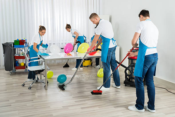 Janitors Cleaning The Office After Party