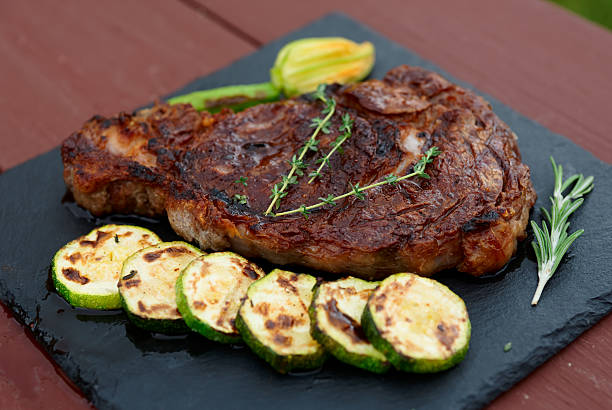 istock Rib eye steak with vegetables on a slate plate 622189962