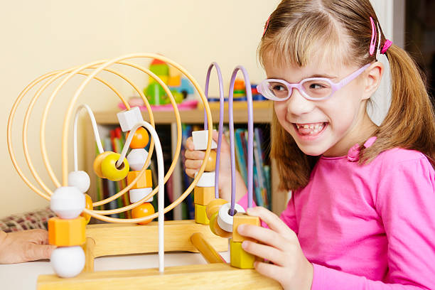 istock Visually disabled child playing with wooden roller coaster bead toy 622191366