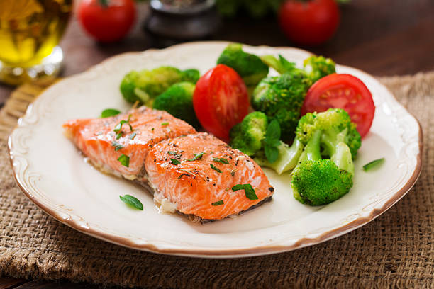 istock Baked fish salmon garnished with broccoli and tomato. 622191578