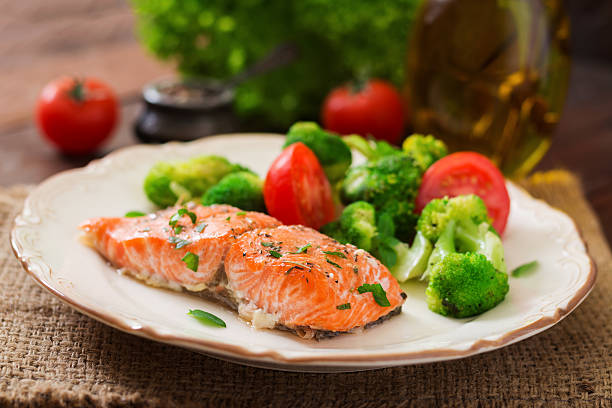 istock Baked fish salmon garnished with broccoli and tomato. 622191704